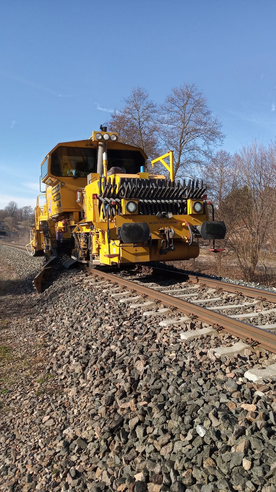 Machine with front plough and buffers and draw gear in Chotěvice location.